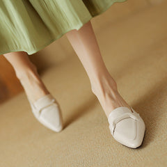 White slip-on leather mules with pointed toe and low block heel
