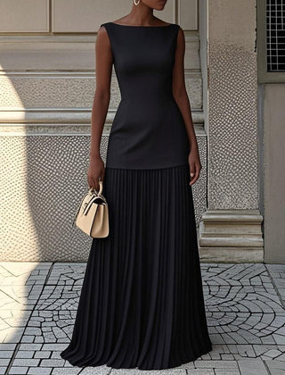 Black pleated sleeveless maxi dress with fitted bodice and tiered skirt.
