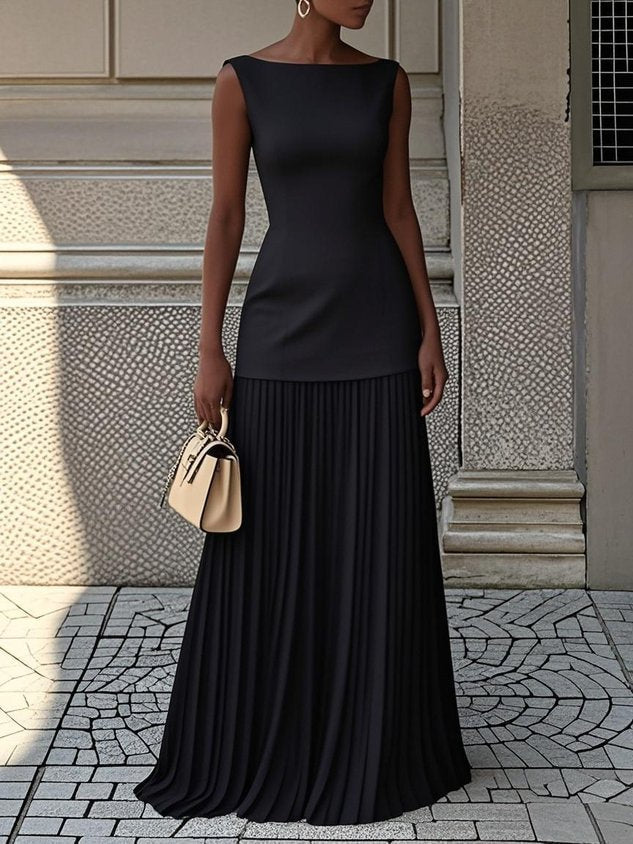 Black pleated sleeveless maxi dress with fitted bodice and tiered skirt.