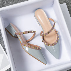 Light blue stud-strap mules with pointed toe and low block heel, side buckle detail