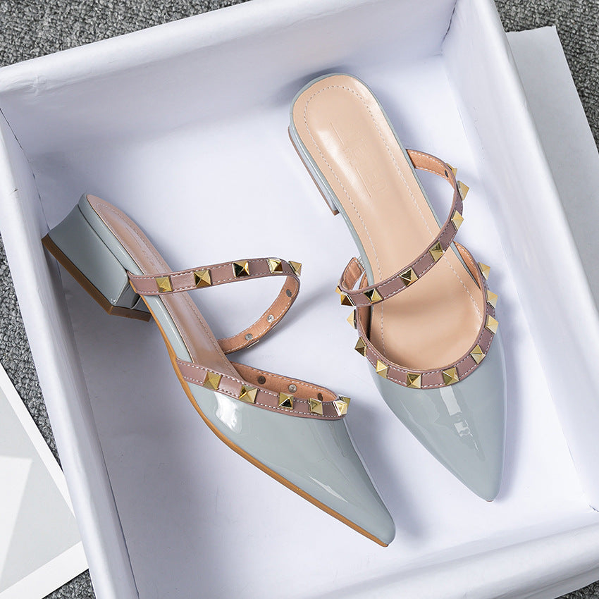 Light blue stud-strap mules with pointed toe and low block heel, side buckle detail