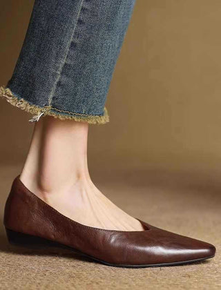 Brown leather pointed-toe mule flats with low heel and slip-on fit