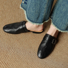 Black leather mules with square buckle strap, textured upper