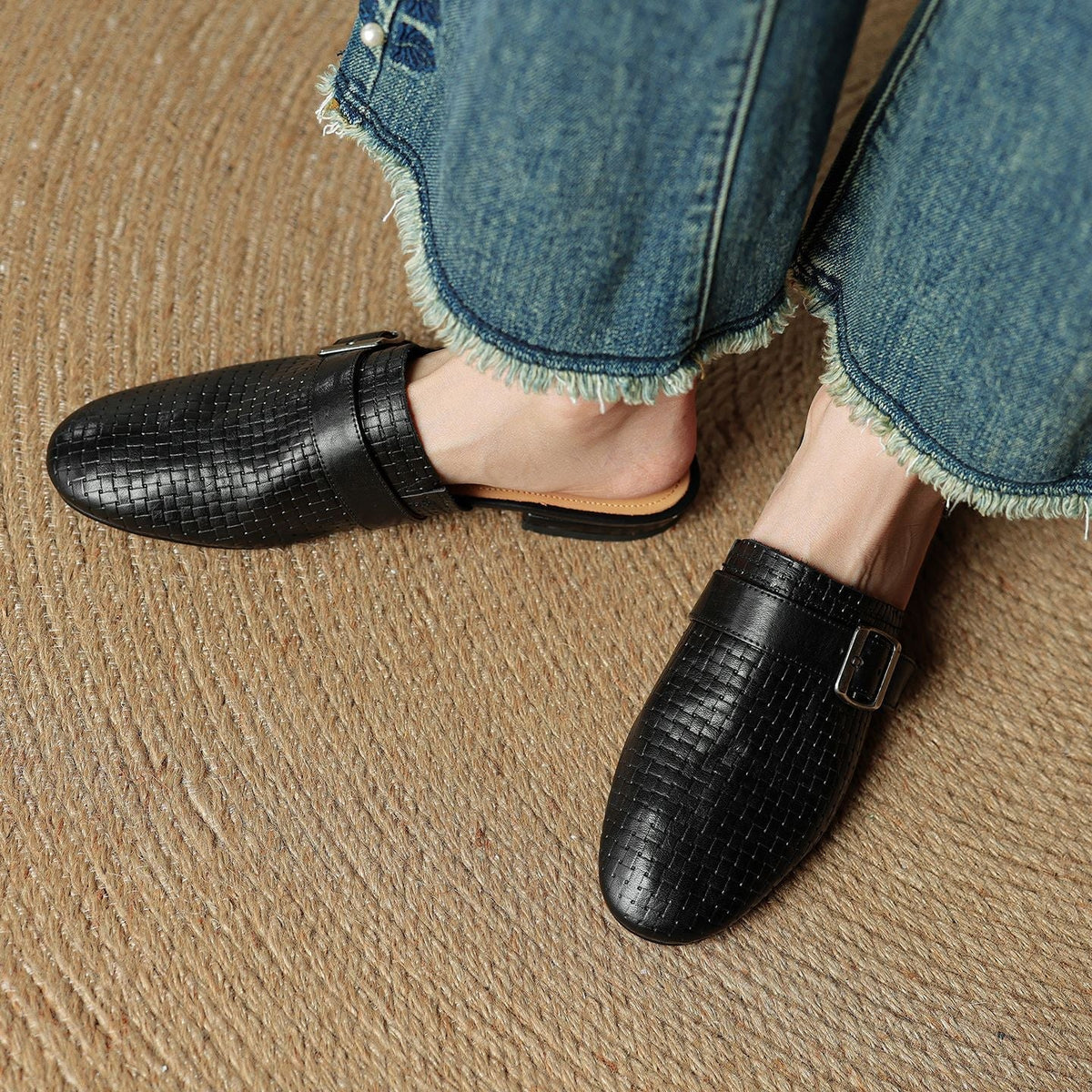 Black leather mules with square buckle strap, textured upper