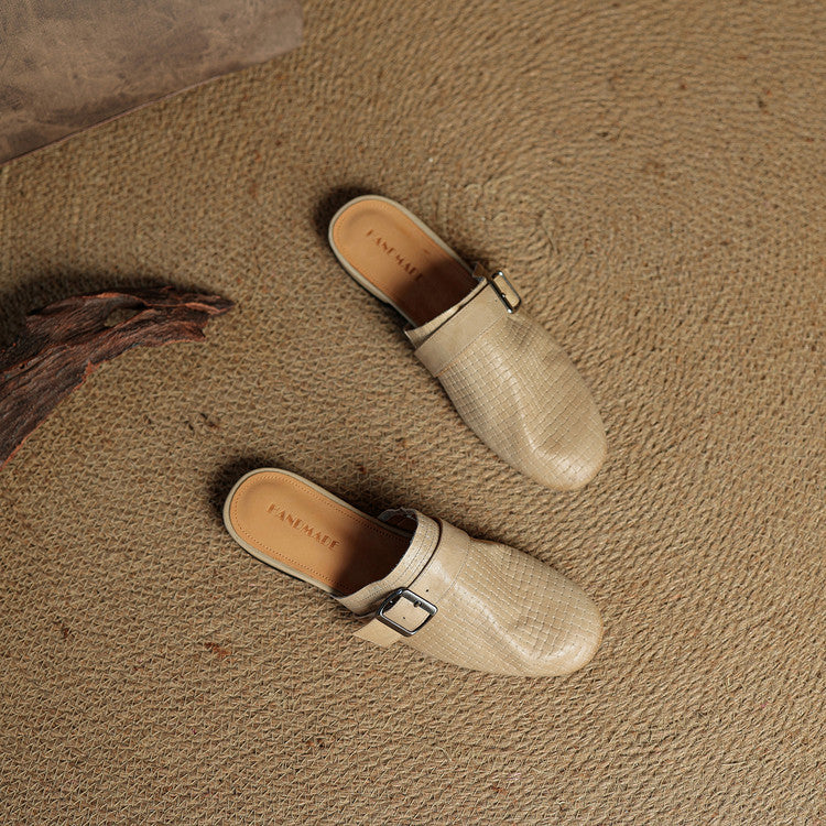 Beige leather mules with square buckle strap, pair on surface