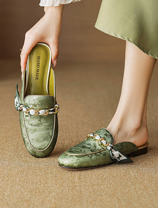 Green genuine leather mules with floral print and knotted bow chain detail, flat slip-on