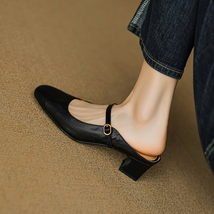 Black leather mule with rounded toe, low block heel, and buckled strap detail
