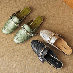 Set of leather mules in green, beige, and black with chain strap detail