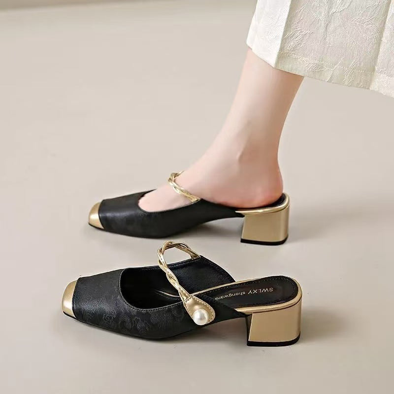 Black genuine leather mules with block heel, chain strap, and round pearl embellishment.