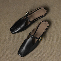 Black leather mules with slingback strap and gold-tone buckle hardware
