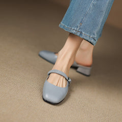 Light blue leather Mary Jane mule, showing elastic strap and low block heel