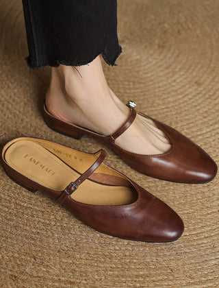 Pair of brown genuine leather mules with cross strap and small buckle, low heel