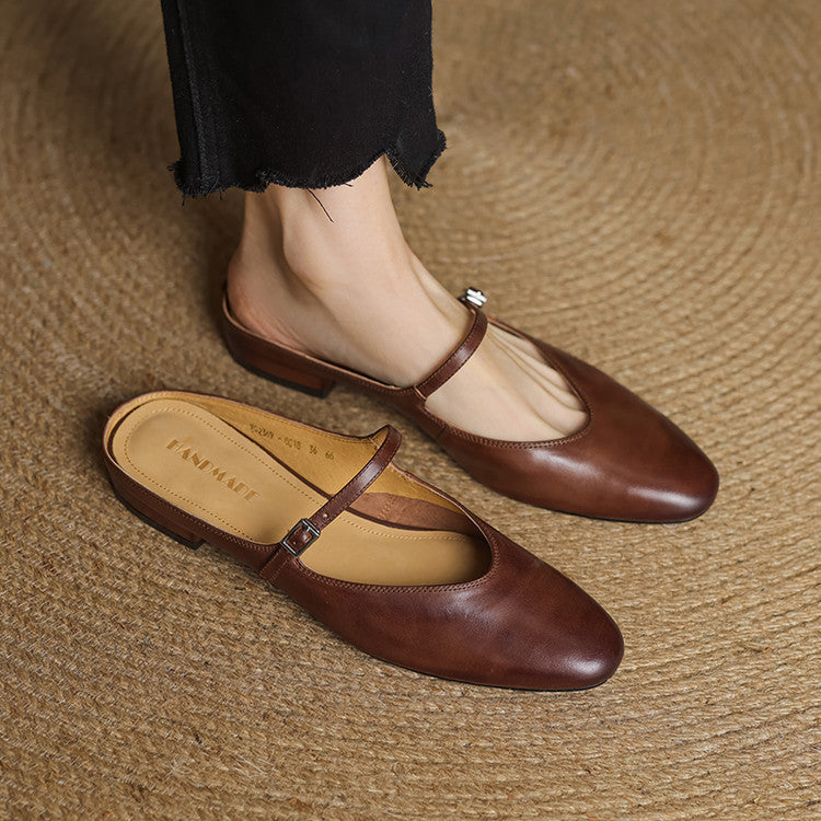 Pair of brown genuine leather mules with cross strap and small buckle, low heel