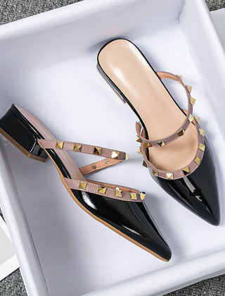 Black patent stud-strap mules with pointed toe and low block heel, side buckle detail