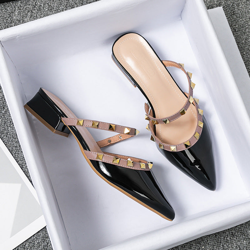 Black patent stud-strap mules with pointed toe and low block heel, side buckle detail