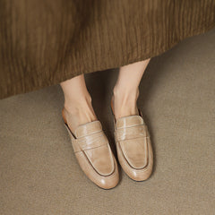 Pair of beige leather mules with slip-on vamp and stitched detail