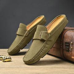 Pair of green suede mules with metal buckle strap and stitched edges