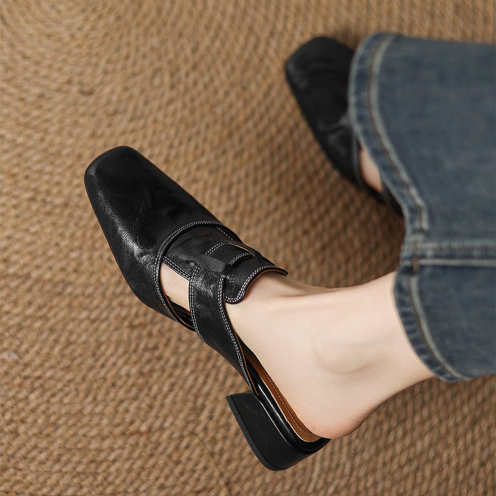 Black leather mule featuring side vamp strap and low block heel