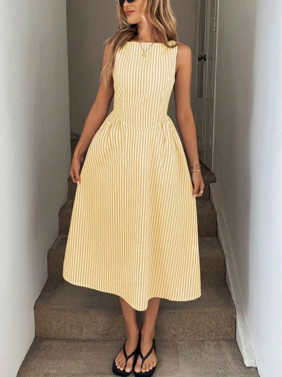 Yellow striped sleeveless maxi dress with gathered skirt and fitted bodice