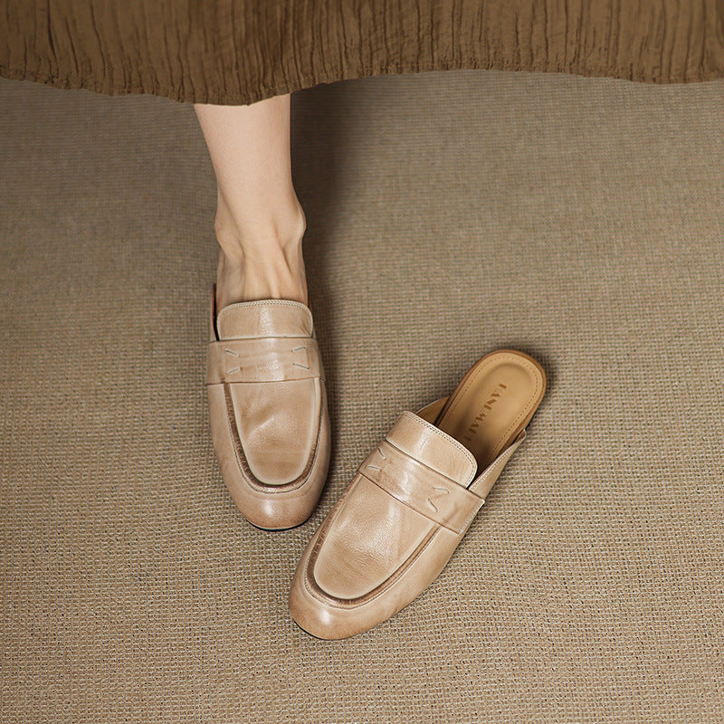 Beige leather mule with slip-on design, low profile, and decorative seam lines