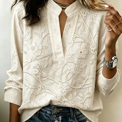 Cream embroidered popover blouse with V-neck and 3/4 sleeves, vine and flower design