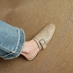 Beige leather mules with square buckle strap and closed toe