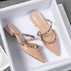 Beige stud-strap mules with pointed toe and low block heel, crisscross strap design