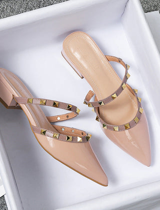 Beige stud-strap mules with pointed toe and low block heel, crisscross strap design