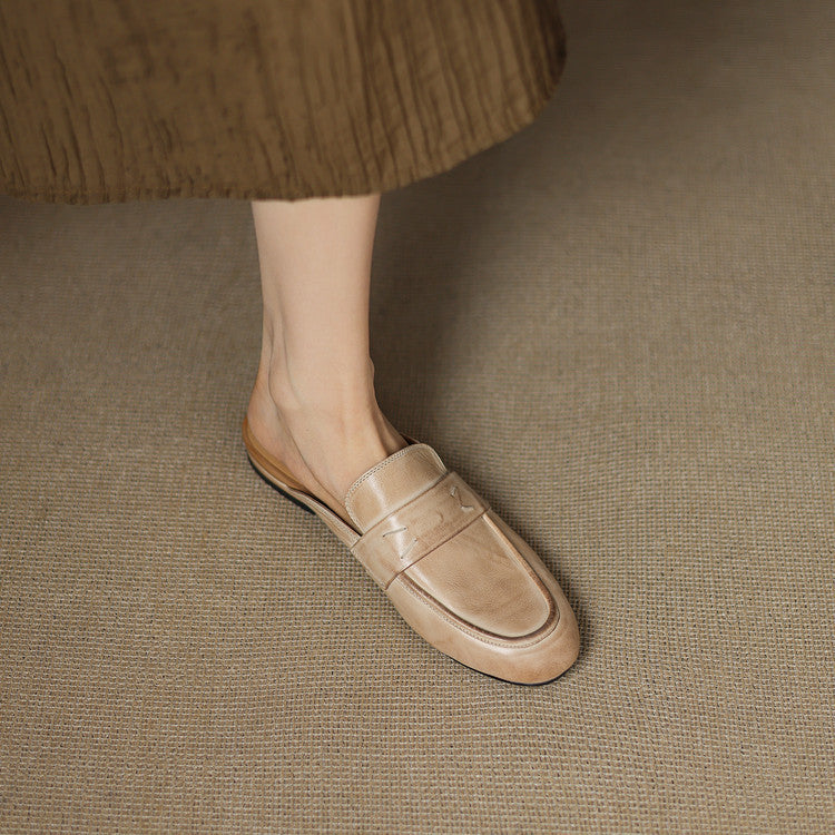 Beige leather slip-on mule with strap-like vamp and flat sole