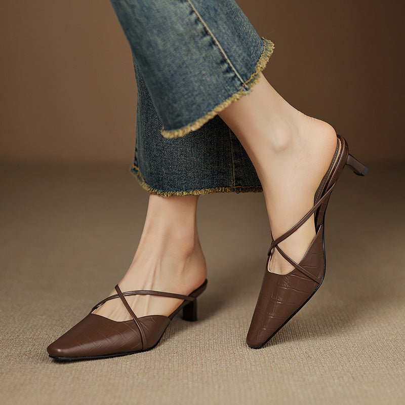 Brown genuine leather mule showing open back, crisscross strap, and mid heel.
