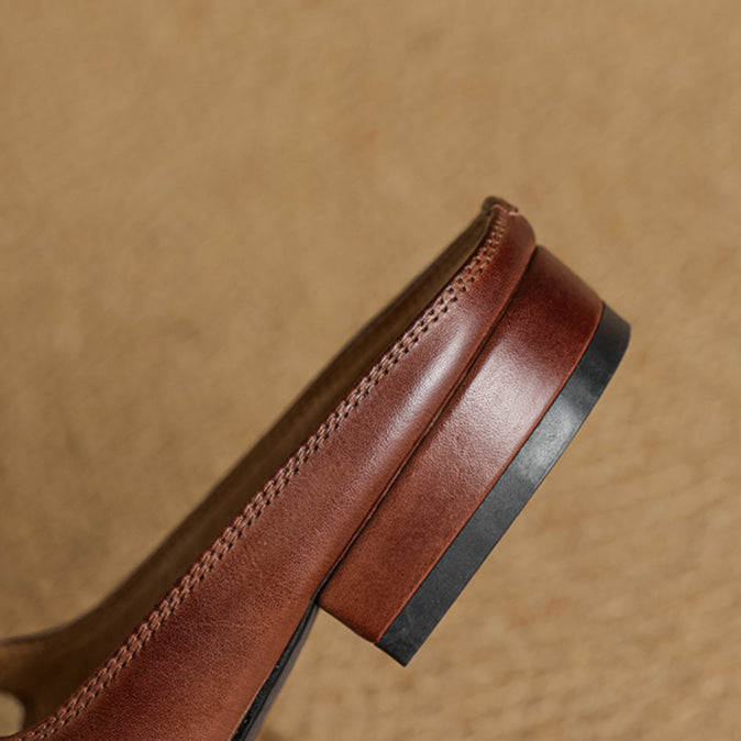 Brown genuine leather mule side view with decorative stitching and low heel