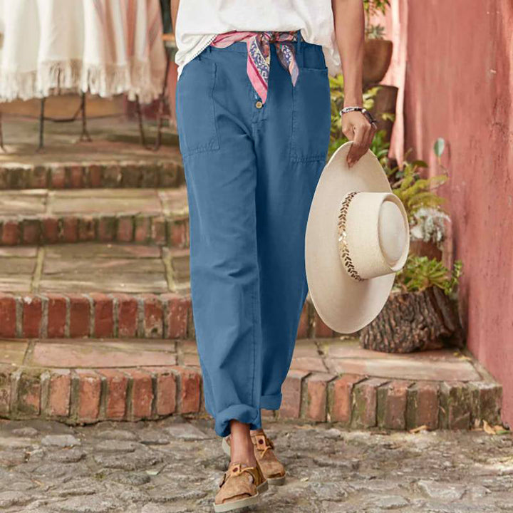 Blue casual pants with button fly, patch pockets, and relaxed cuffed ankles