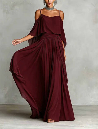 Wine red draped cold-shoulder maxi dress with flowing cape sleeves and pleated skirt