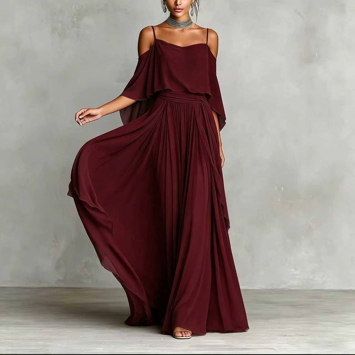 Wine red draped cold-shoulder maxi dress with flowing cape sleeves and pleated skirt