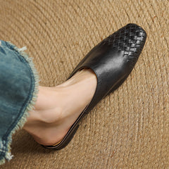 Black woven leather mule with open toe and low flat sole