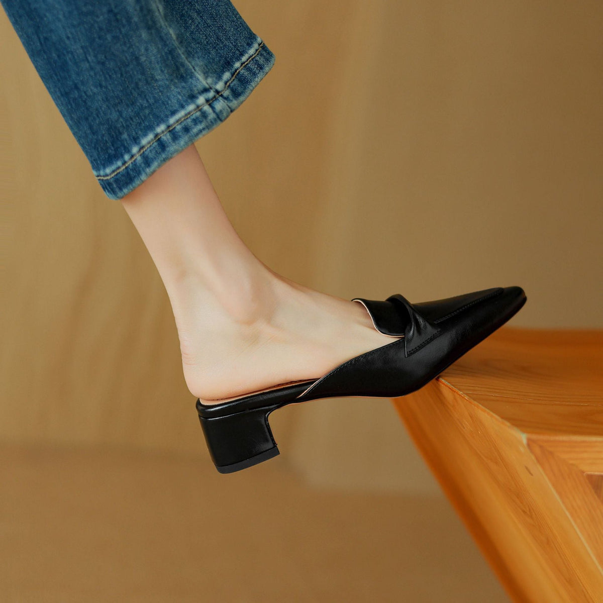 Black leather slip-on mule with pointed toe and low block heel