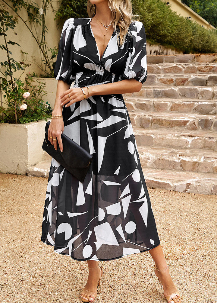 Black and white abstract midi dress with V-neck, puff sleeves, and front button placket