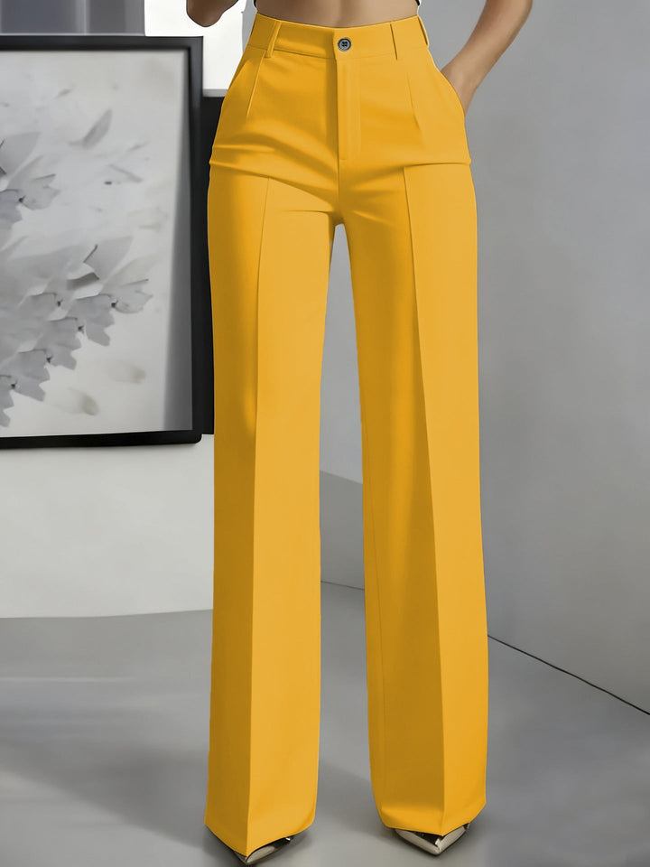 Mustard yellow high-waisted straight-leg trousers with front button and pressed creases