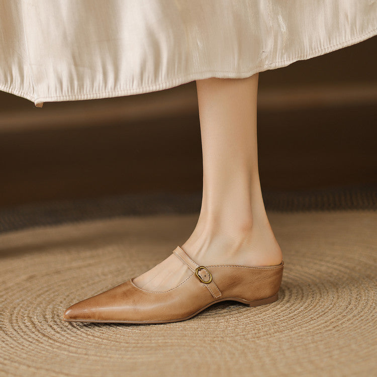 Tan leather mules with pointed toe and round buckle ankle strap
