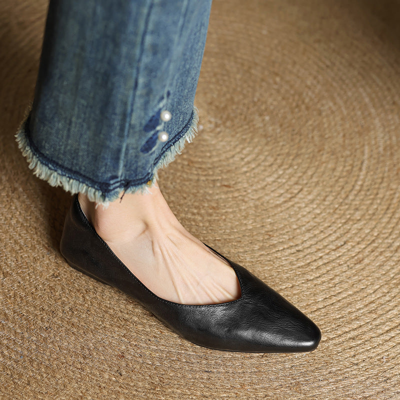 Black genuine leather mules with almond toe and low profile sole