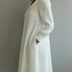 White embroidered midi dress with V-neck and long sleeves, A-line silhouette