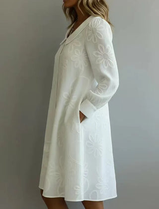 White embroidered midi dress with V-neck and long sleeves, A-line silhouette