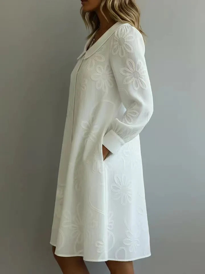 White embroidered midi dress with V-neck and long sleeves, A-line silhouette