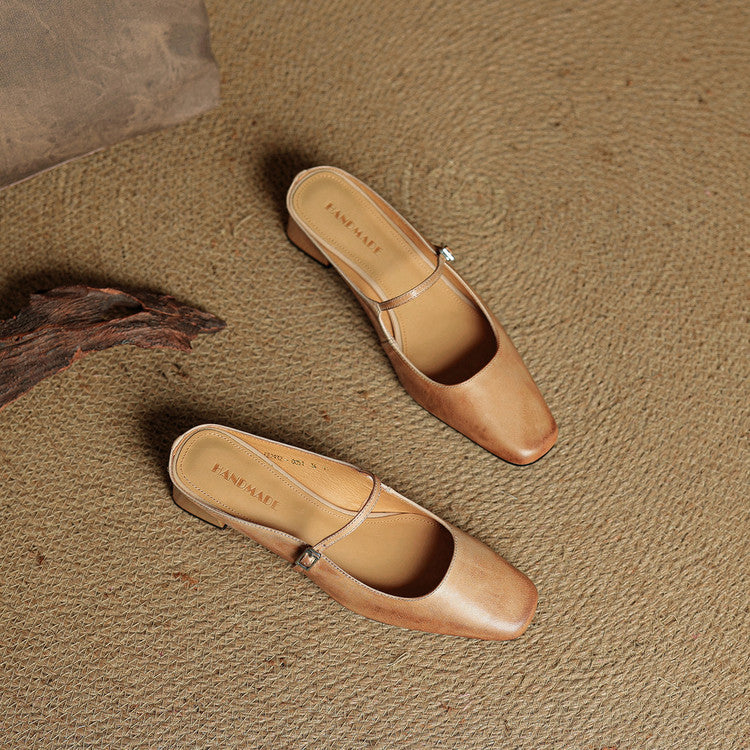 Two apricot leather mules with square toe, side buckle strap, and low block heel