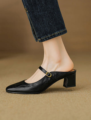 Black leather mule with low block heel and adjustable strap with gold buckle detail.