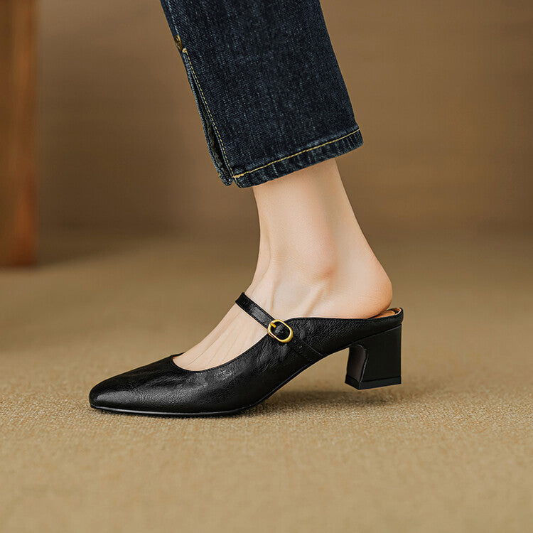 Black leather mule with low block heel and adjustable strap with gold buckle detail.