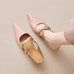 Pair of pink textured leather mules with pointed toe and gold ankle-strap buckles.