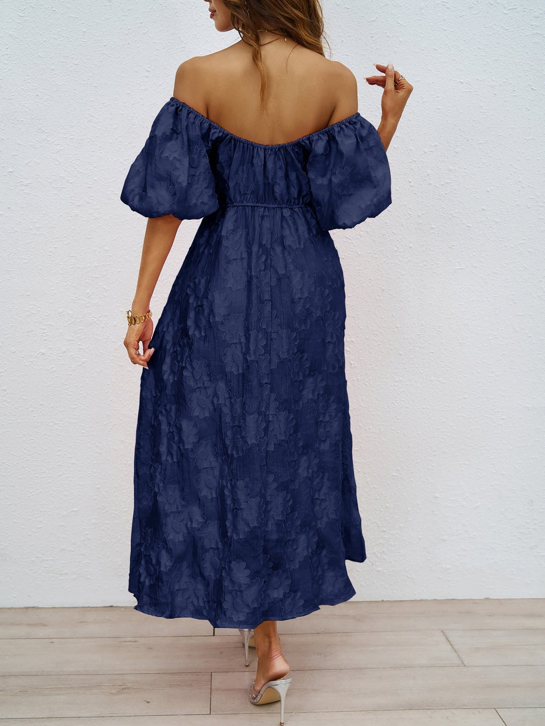 Navy off-shoulder midi dress from back view with puff sleeves and waist gathers
