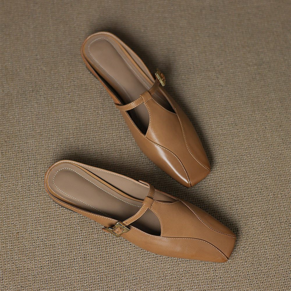 Brown leather mules, pointed toe with strap and gold hardware, pair on ground