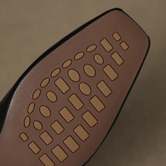 Leather mule outsole with embossed tread pattern